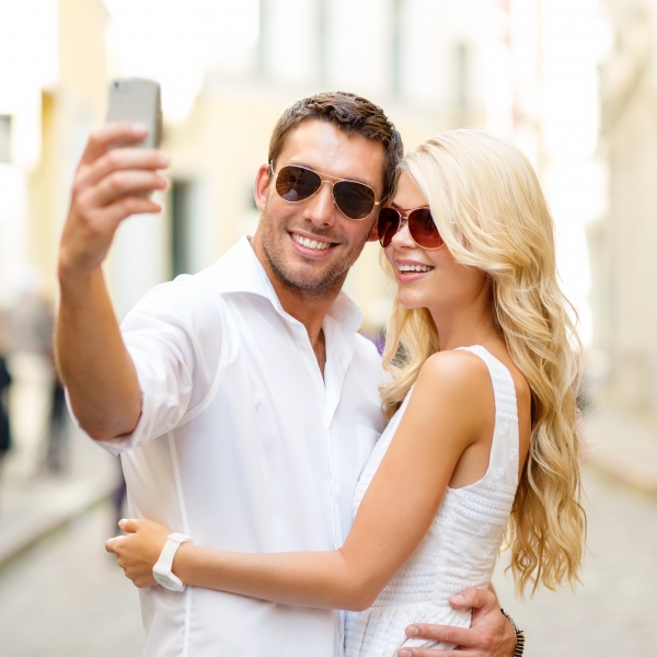 9170568-smiling-couple-taking-selfie-with-smartphone